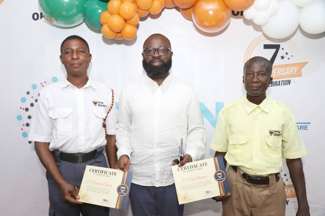 Two Offin Security guards holding certificates of appreciation